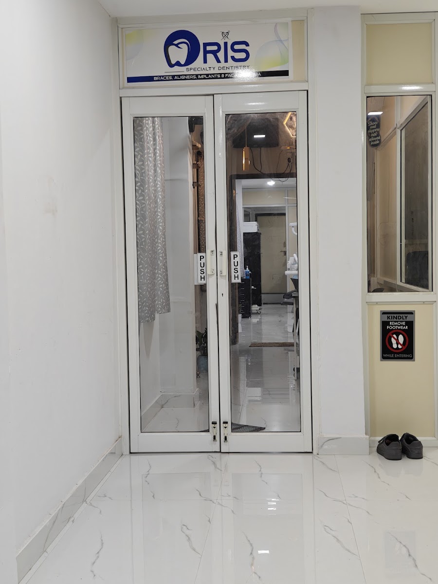 Real clinic entrance with glass architectural framing at ORIS Speciality Dentistry