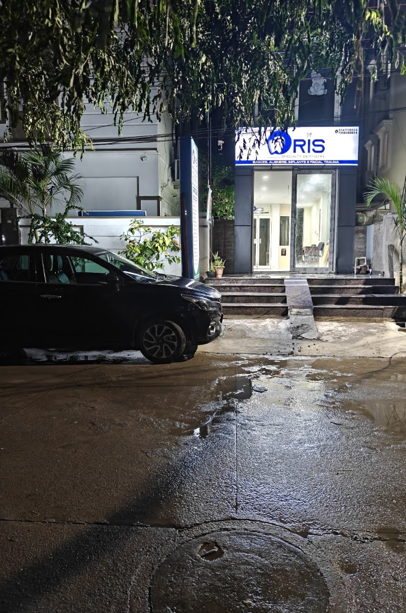 Real illuminated night exterior of ORIS Speciality Dentistry in Miyapur
